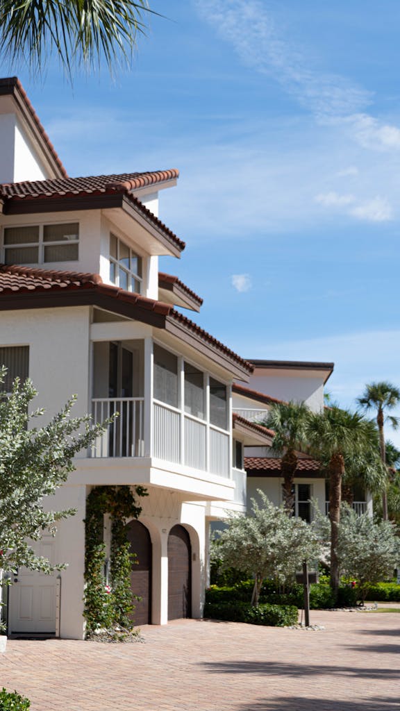 Beautiful beachfront home in Florida City with lush palm trees and clear skies.
